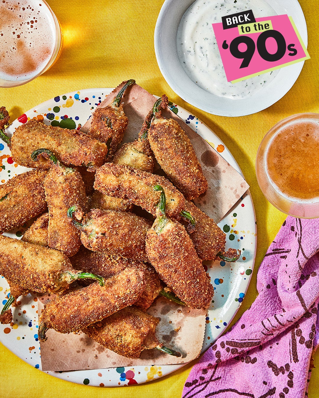 A plate with jalapeño filled with cheese, which is roasted or fried.