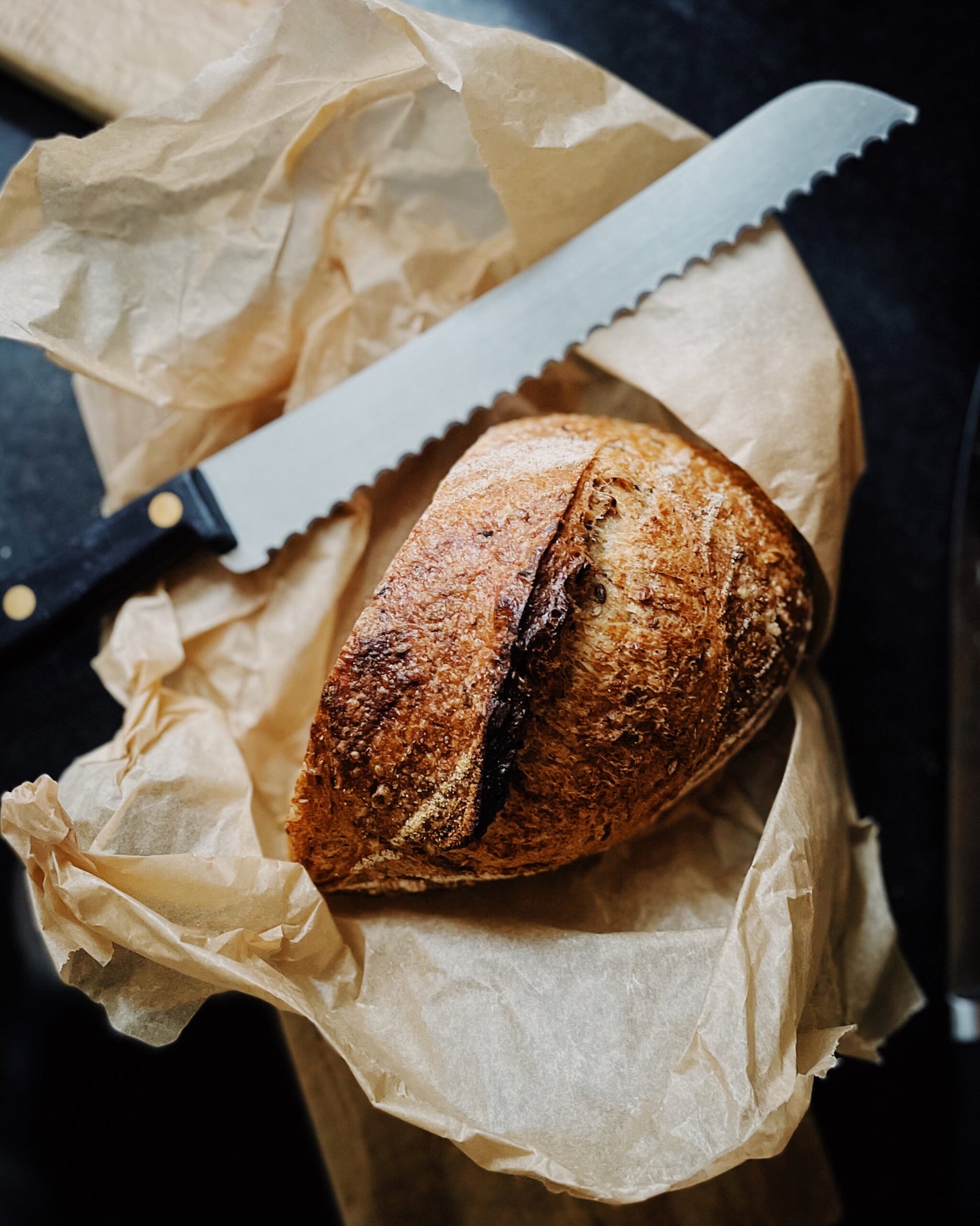 Bread knife with loaf of bread